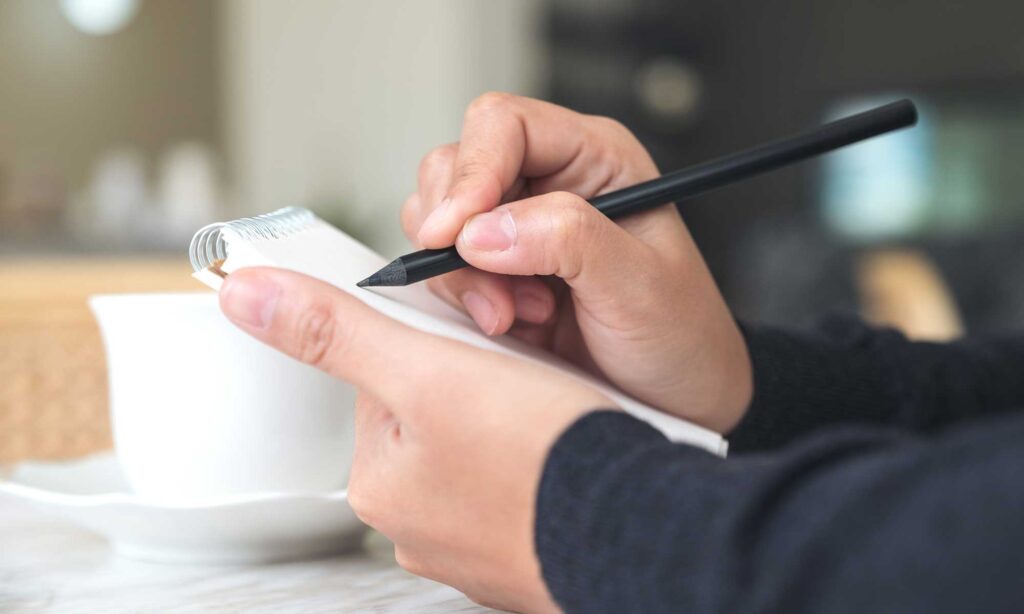 Closeup of a hand making notes